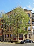 Apartment house in a corner and closed development