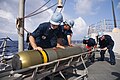 Defense.gov News Photo 110604-N-CB621-047 - U.S. Navy sailors aboard the guided missile destroyer USS Chung-Hoon DDG 93 load a Mark 46 torpedo into a launcher while underway in the Pacific.jpg