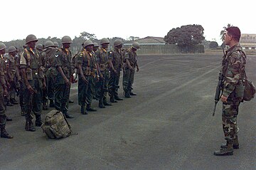 Master Sergeant Thomas A. Nelson (right) of the 3rd US Army Special Forces Group inspects Ghanaian troops of ECOMOG at Roberts International Airport located outside of Monrovia, Liberia ECOMOG Soldiers from Ghana.JPEG