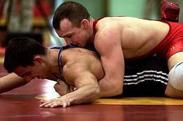 Even on the mat, a Greco-Roman wrestler must still find ways to turn his opponent's shoulders to the mat for a fall without using the legs. GrecoRomanWrestling2.jpg