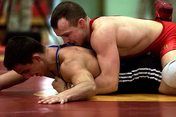 Even on the mat, a Greco-Roman wrestler must still find ways to turn his opponent's shoulders to the mat for a fall without using the legs.