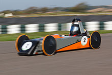 A Greenpower F24+ car, "Fireblade" driven by Ross competing at Goodwood in the final round of the 2011 Formula 24+ championship. Greenpower Formula 24+ car at Goodwood.jpg