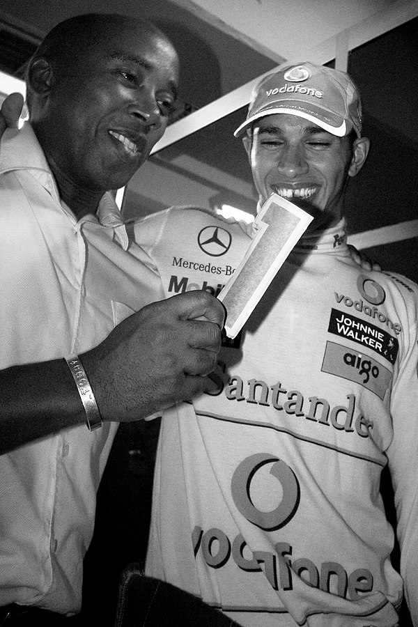 Hamilton celebrating with his father and then-manager Anthony Hamilton after the 2008 Brazilian Grand Prix