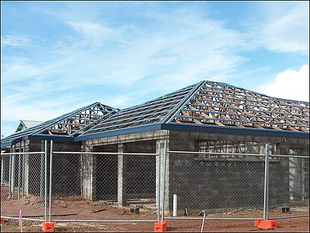 A hip roof construction in Northern Australia showing multinail truss construction. The blue pieces are roll-formed metal roof battens or purlins