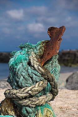 Knotted rope tied around an iron picket at a beach on island Helgoland, Germany