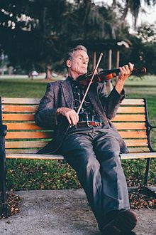 Man Playing Violin on Bench at Park.jpg