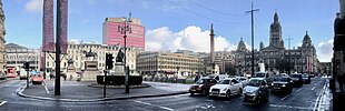 The south elevation of the tower in 2019 from George Square, showing the "People Make Glasgow" placard. Panorama George Square north side to City Chambers.jpg