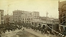 The Yesler Block in 1891, showing all that would be built of Elmer Fisher's original design. Parade on 1st Ave south from Yesler Way in celebration of President Benjamin Harrison's visit to Seattle on May 6, 1891 (CURTIS 2070).jpeg