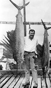 Author Ernest Hemingway (middle) in Key West, Florida, USA, in the 1940s, with a sailfish he had caught Portrait of author Ernest Hemingway posing with sailfish Key West, Florida.jpg