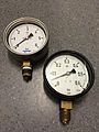 Two industrial pressure gauges.