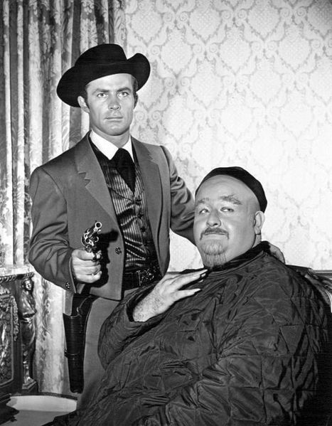 Robert Conrad as special agent Jim West and Victor Buono guest-starring as a Chinese merchant from the premiere of the television series The Wild Wild