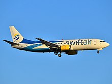 iAero Boeing 737-400 in former Swift Air branding. Swift Air Boeing 737-4Q8 N807TJ approaching JFK Airport.jpg