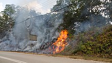 Bush fires beside a road in Tambunan in the Interior Division on 23 March 2016. Tambunan-District Sabah Bushfire-02.jpg