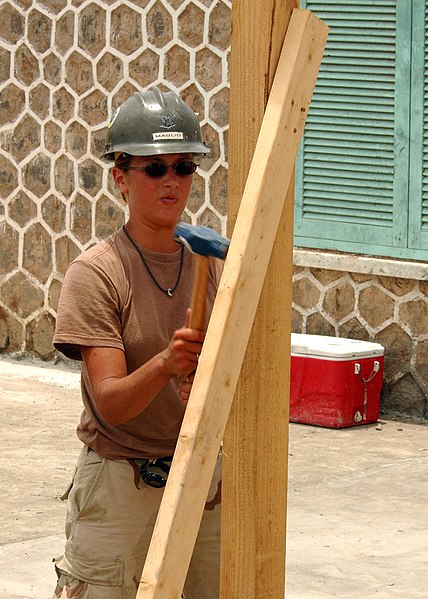 File:US Navy 050506-N-5526M-001 Builder 3rd Class Jaqueline Maglio from Rome, New York, assigned to Naval Mobile Construction Battalion One (NMCB-1) stationed out of Gulf Port, Miss., removes braces used to help support a concrete s.jpg