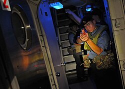 US Navy 100506-N-7643B-169 A sailor from the Royal Brunei Navy posts watch on a passage way during a visit, board, search, and seizure exercise aboard the U.S. Coast Guard cutter Mellon (WHEC 717).jpg