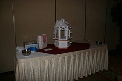 A wishing well on the gift table of a wedding reception. Wishing well wedding.jpg