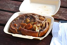 A Yorkshire pudding filled with mashed potato, beef, gravy and vegetables