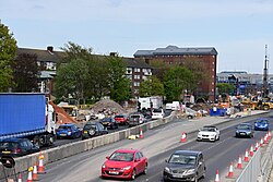 A view towards the A63 from the Porter Street Bridge in Kingston upon Hull. Eastbound traffic has been temporarily moved into two lanes on the soon-to-be eastbound sliproad, with temporary traffic lights now causing regular congestion on the road.