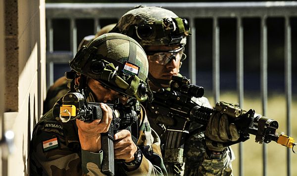 Indian soldiers from the 6th Battalion, Kumaon Regiment pull security before entering a room while conducting company movement procedures with the Uni