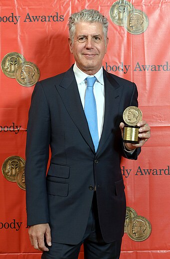Bourdain with his Peabody Award in 2014
