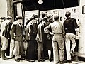 Crowd at Allied picture display in windows of the Psychological Warfare Division, Cherbourg, 1944 (24629609094).jpg