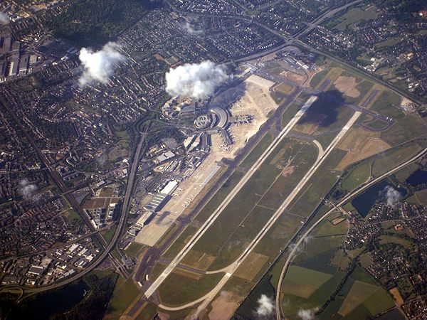 Aerial view of the airport; the station is visible on the bottom left end of the runway