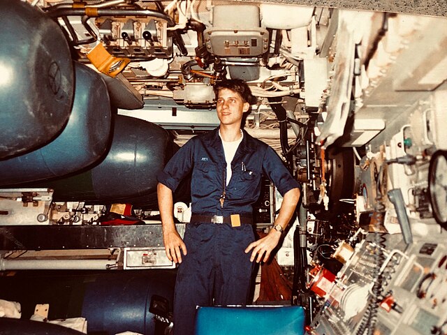 Image: David Ayer wearing coveralls in submarine's torpedo room