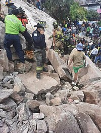 Rescue workers searching the rubble of a collapsed building in Cerro del Chiquihuite, Mexico. Deslave en el Cerro del Chiquihuite (16313410905186558).jpg