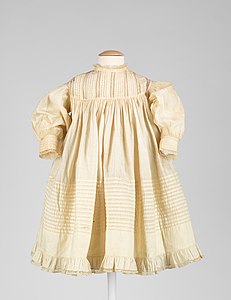 A hand-sewn infant's cotton dress from the United States, c. 1890.