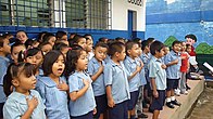 Salvadoran school children singing national anthem