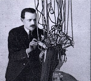 Eugene Suter using early heaters designed by Isidoro Calvete. The heaters had two windings that heated the ends and roots separately Eugene shown in 1920 advert.jpg