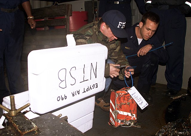 An FBI agent tags the cockpit voice recorder from EgyptAir Flight 990 on the deck of the USS Grapple (ARS 53) at the crash site on November 13, 1999