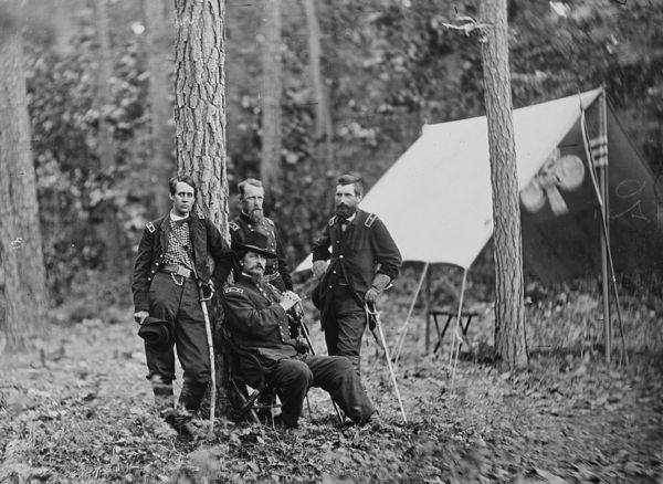 Maj. Gen. Winfield S. Hancock and generals during the Overland Campaign. Standing, from left to right, are Barlow (wearing his familiar checked shirt)
