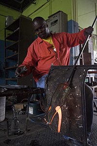 James Magaula forming a giraffe handle for a jug