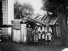 Karafuto (Sakhalin) Ainu family behind their house in 1912. Karafuto Ainu House 1912 (No.1066).jpg
