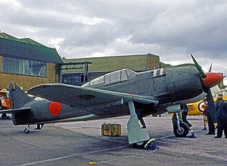 RAF Tern Hill in 1962 with the main station hangars at the rear. A preserved Japanese Kawasaki Ki-100 is displayed in the foreground. Kawasaki Ki100 TH 15.09.62 edited-2.jpg