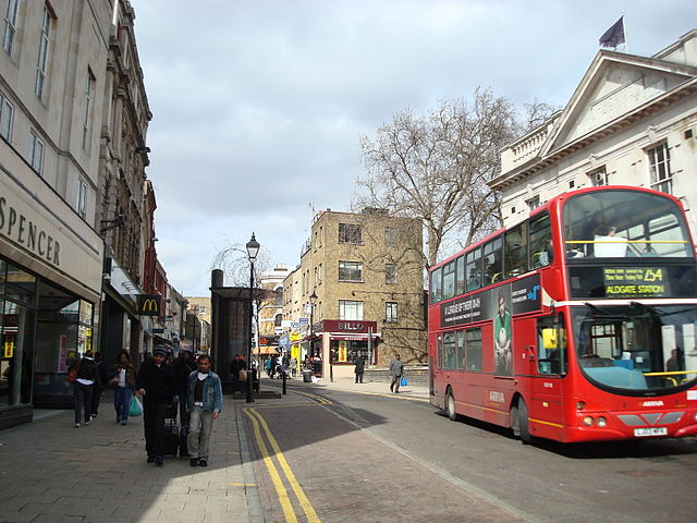 An Arriva London bus passes a branch of Marks & Spencer