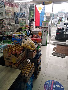 Setup of the counter area of a convenience store in Quezon City. Plastic sheets are installed to limit COVID-19 transmission. PH-COVID19 7-Eleven-shop counter.jpg