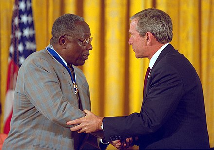 Aaron accepting the Presidential Medal of Freedom from US President George W. Bush in 2002