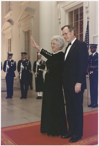 President Bush and the First Lady await the arrival of a head of state at the White House.