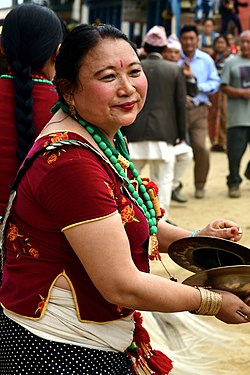Woman with Jhyamta cymbals, Nepal.