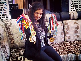 Rucha Pujari with her collection of medals from National, Asian, Commonwealth and World events Rucha Pujari medal collection 2016.jpg