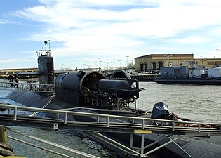 Un sous-marin de poche SEAL Delivery Vehicle, servant à engager des plongeurs des SEAL, en chargement dans la valise sèche du sous-marin américain USS Dallas (SSN-700), équipé en bâtiment base de plongeur