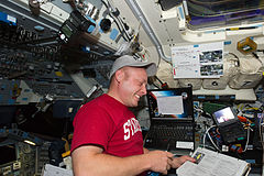 EVA 1 choreographer Michael Fincke works on the aft flight deck of Endeavour
