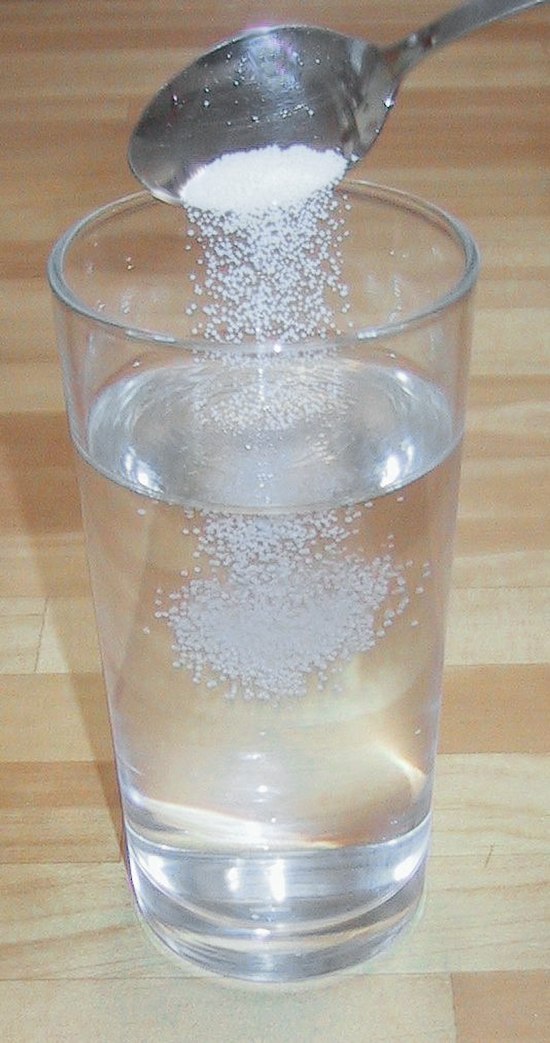 Making a saline water solution by dissolving table salt (NaCl) in water. The salt is the solute and the water the solvent.