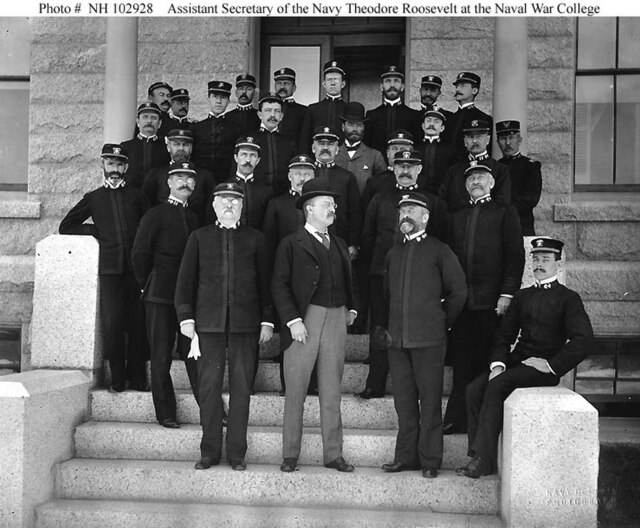 Assistant Secretary of the Navy Theodore Roosevelt on the steps of the Naval War College with faculty and students