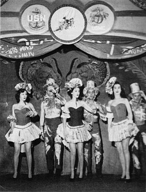 Three women and three men on stage in a chorus number