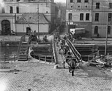 Horse transport crossing a temporary bridge over the canal in Douai after its occupation by the 8th Division. The Hundred Days Offensive, August-november 1918 Q7155.jpg