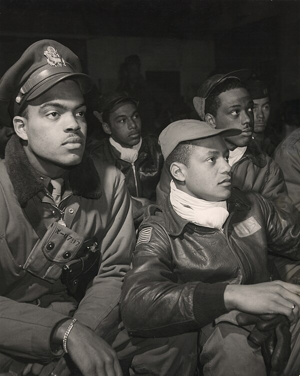 Tuskegee Airmen of the 332nd Fighter Group, United States Army Air Forces (USAAF), attend a briefing at Ramitelli Airfield, Italy in March 1945.