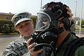 U.S. Army Spc. Amanda K. Schinkel, left, a chemical operations specialist assigned to the Reconnaissance Platoon, 61st Chemical Company, 115th Fires Brigade, attaches an oxygen hose to the protective mask of a 091118-A-PT935-512.jpg